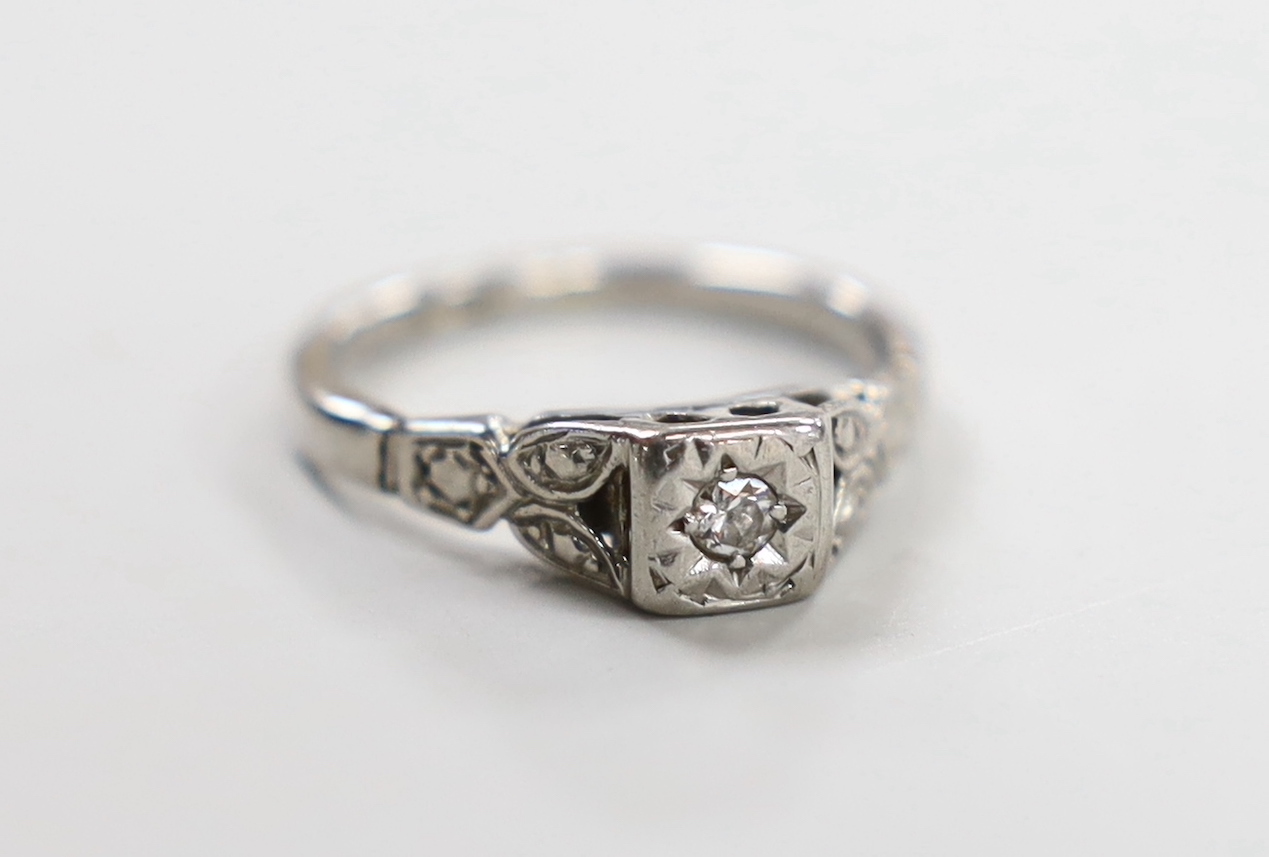 A white metal (stamped PALL?) and illusion set single stone diamond ring, size J/K, gross weight 2.3 grams.